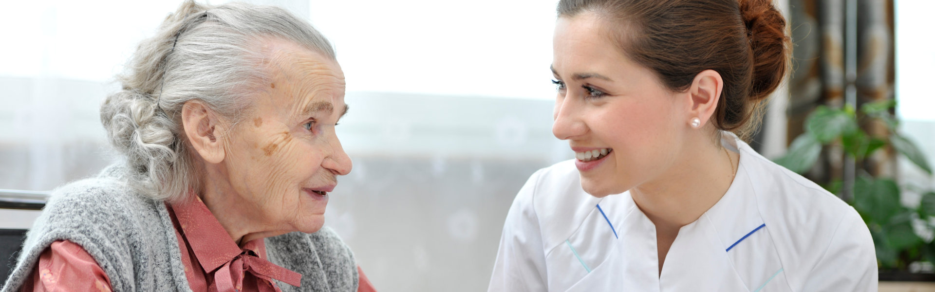 caregiver assist her patient in eating