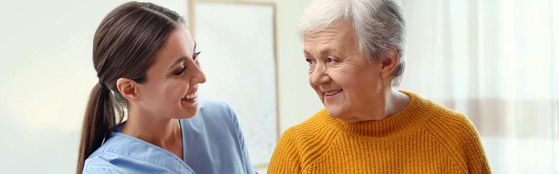 caregiver assist her patient in standing